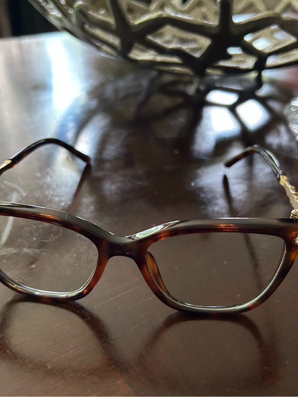 Tortoise shell glasses with clear non prescription lenses.  Jeweled sides.